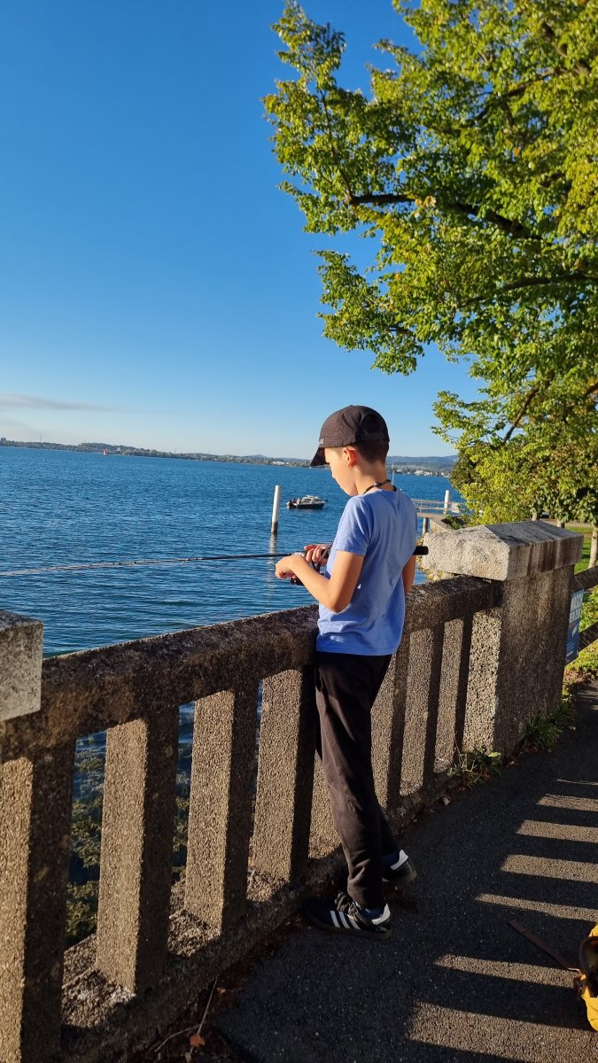 Young anglers casting and fishing on Lake Zug