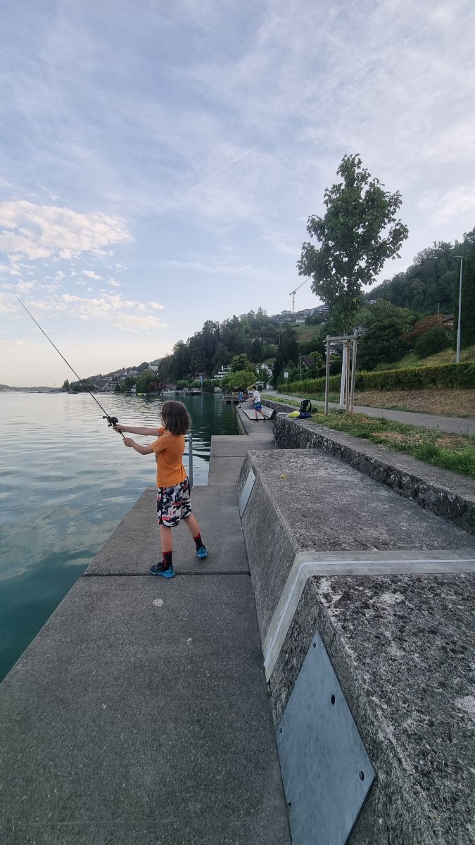 Julian casting out along the concrete lakeside wall