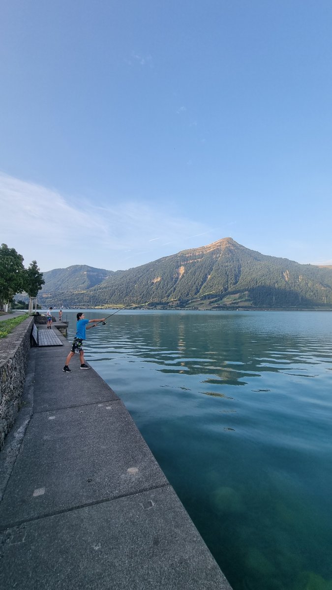 Sophie casting over clear water with the mountain backdrop